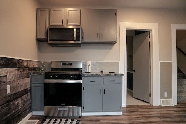 kitchen featuring gray cabinets, light hardwood / wood-style flooring, and appliances with stainless steel finishes