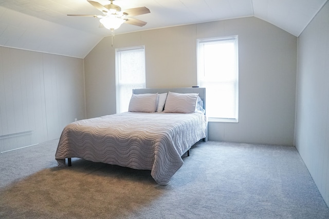 carpeted bedroom with multiple windows, ceiling fan, and lofted ceiling