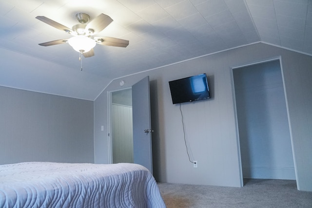 bedroom featuring ceiling fan, carpet floors, and vaulted ceiling