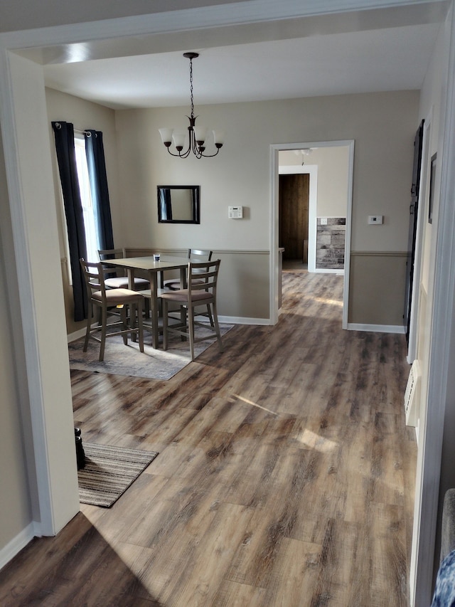 dining space with a chandelier and wood-type flooring