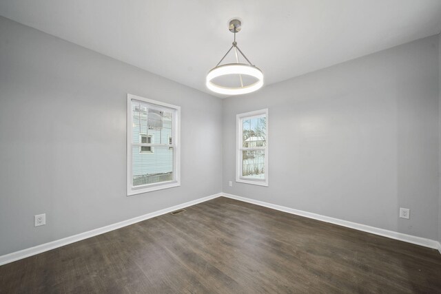 140 Stanley Ave, Jackson, MI 49203 - empty room with baseboards and dark wood-style floors