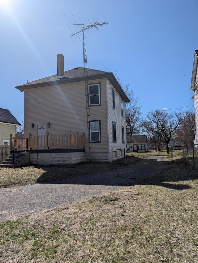 140 Stanley Ave, Jackson, MI 49203 - view of side of property featuring a wooden deck and a chimney