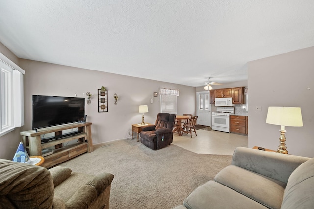 carpeted living room featuring ceiling fan