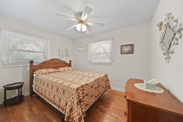 bedroom featuring ceiling fan and dark wood-type flooring