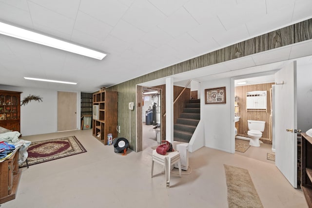 basement featuring wood walls