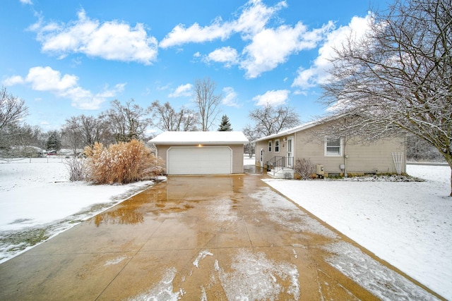 view of front of home with a garage and an outdoor structure