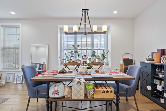 dining area with a chandelier and light wood-type flooring