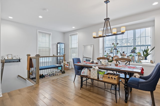 dining area featuring hardwood / wood-style flooring and an inviting chandelier