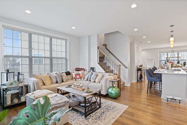 living room with a chandelier and light wood-type flooring