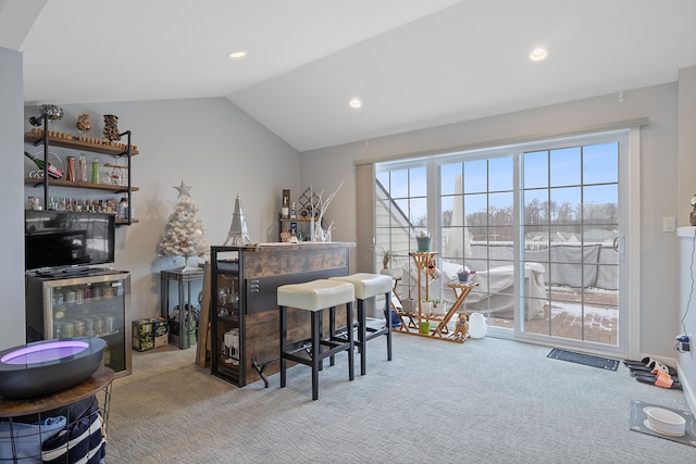 carpeted office space with wine cooler, lofted ceiling, and indoor bar