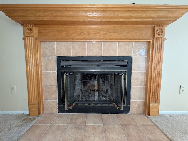 details with a tile fireplace