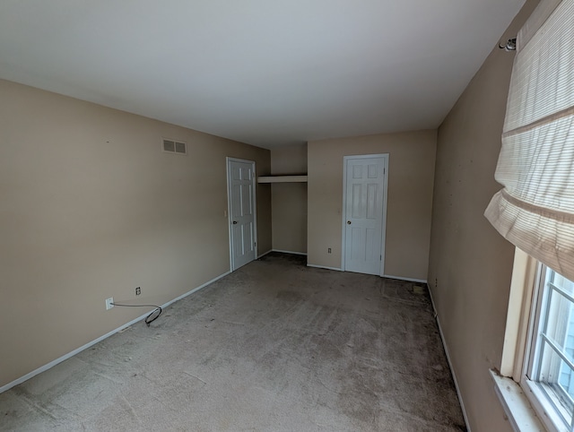 unfurnished bedroom with light colored carpet