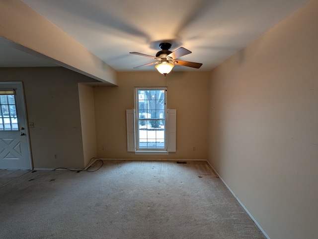 carpeted empty room featuring ceiling fan