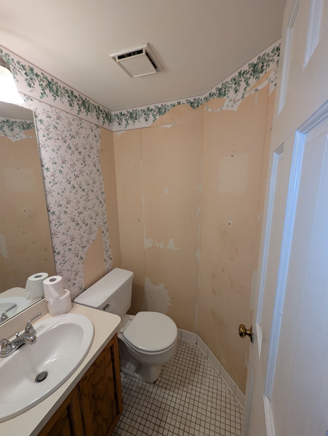 bathroom featuring vanity, tile patterned flooring, and toilet