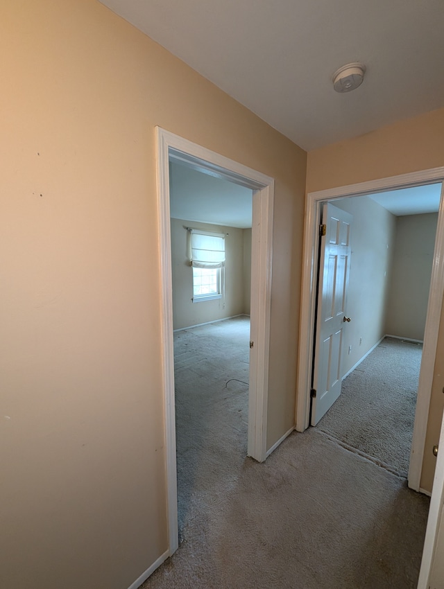 hallway with light colored carpet