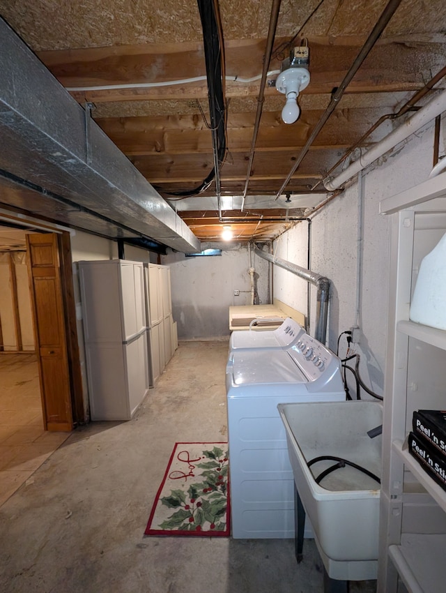 clothes washing area featuring sink and washing machine and dryer