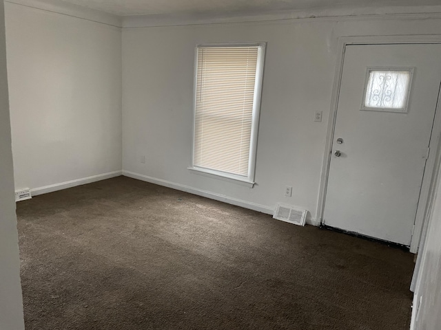 foyer entrance with dark colored carpet