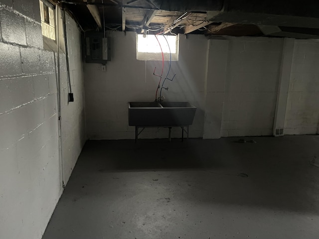 basement with electric panel and sink