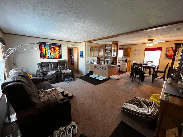 carpeted living room with ceiling fan, a textured ceiling, and ornamental molding