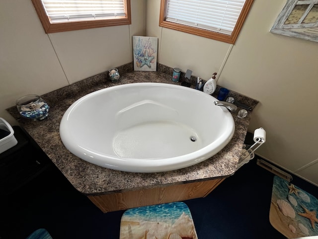 bathroom with a tub to relax in