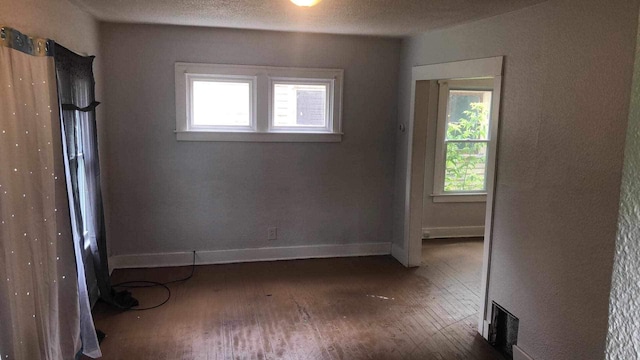 empty room with dark wood-type flooring