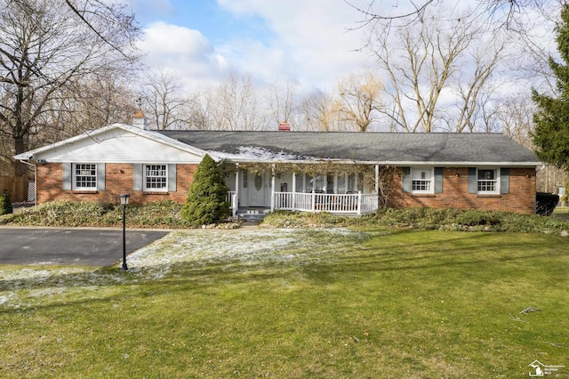 ranch-style house featuring a front yard and a porch