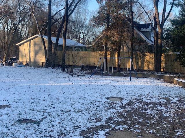 snowy yard with a playground