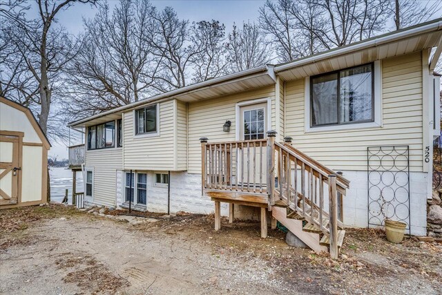 back of property featuring a storage unit