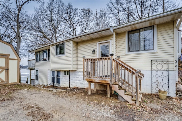 back of property with a storage unit and an outdoor structure