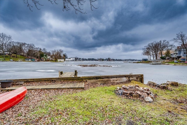 view of yard featuring a boat dock and a water view