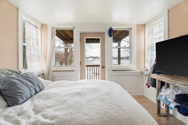 bedroom featuring access to outside and light hardwood / wood-style flooring