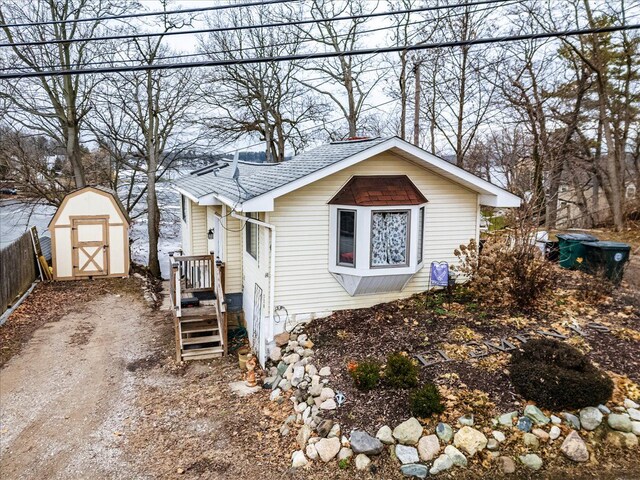 view of front facade with a storage shed