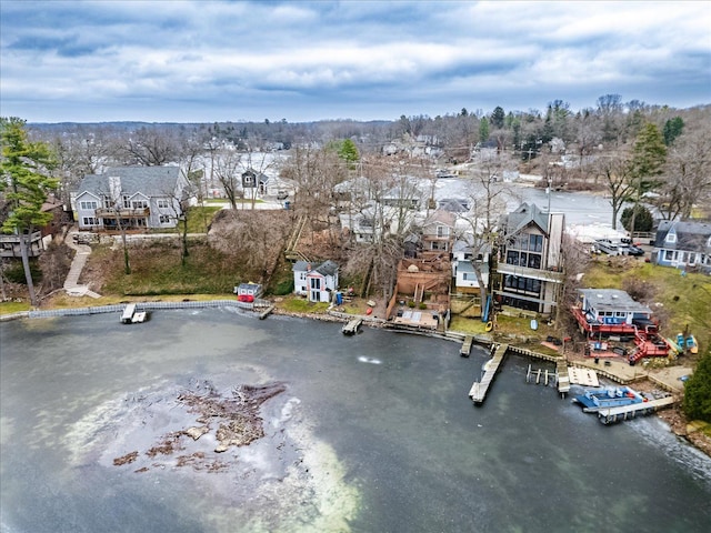 drone / aerial view featuring a water view and a residential view