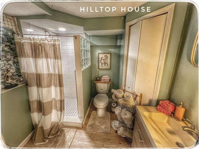 full bathroom with vanity, a shower stall, toilet, and wood finished floors