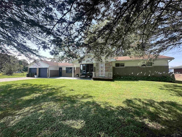 view of front of property with a garage and a front yard