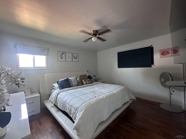 bedroom with ceiling fan and dark hardwood / wood-style flooring