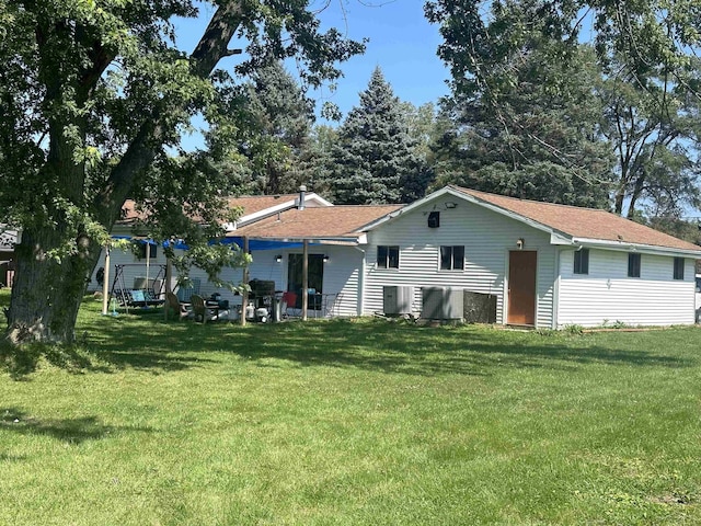 rear view of house featuring a yard