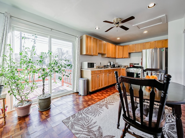 kitchen with dark parquet floors and stainless steel appliances