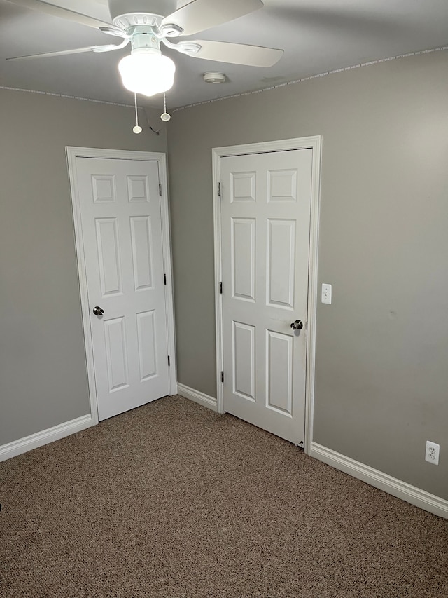 unfurnished bedroom featuring carpet and ceiling fan