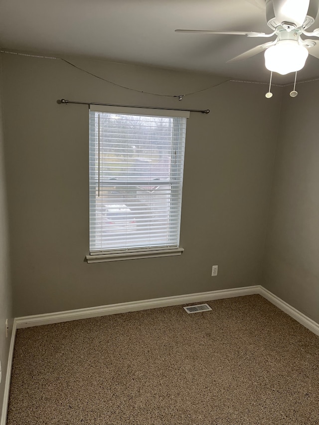 empty room with carpet flooring and ceiling fan