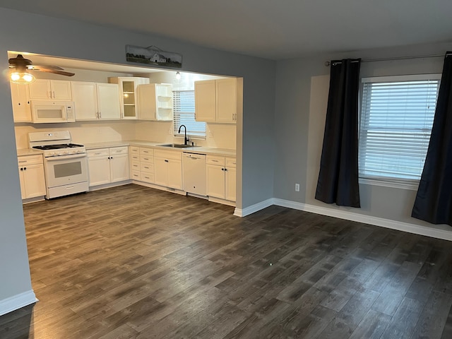 kitchen featuring dark hardwood / wood-style flooring, sink, white cabinets, and white appliances