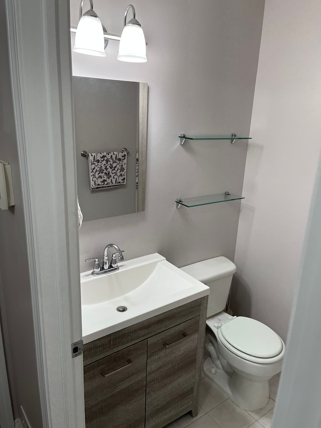 bathroom with tile patterned flooring, vanity, and toilet