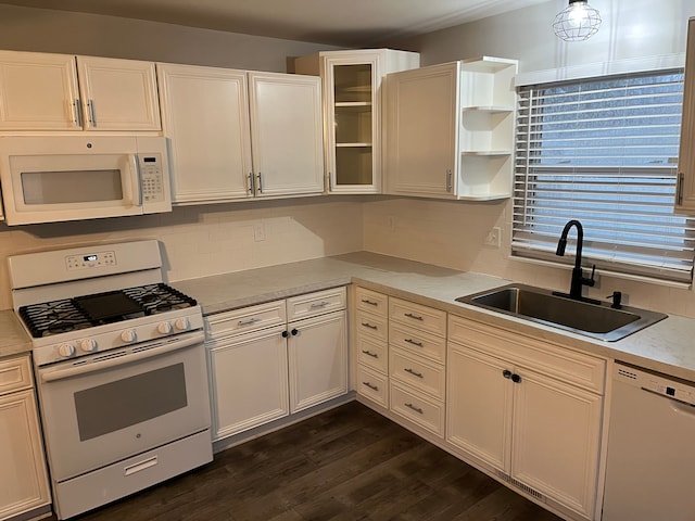 kitchen featuring white appliances, white cabinetry, and sink