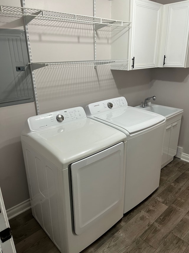 laundry area featuring washer and clothes dryer, cabinets, and dark hardwood / wood-style floors