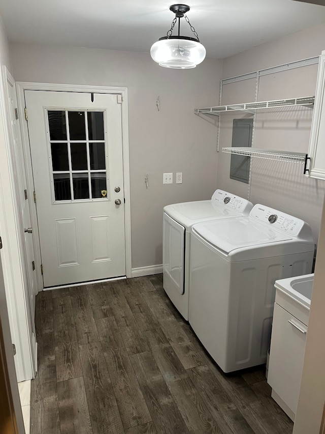 laundry room featuring cabinets, independent washer and dryer, and dark hardwood / wood-style flooring