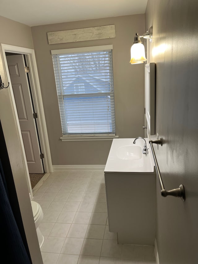 bathroom featuring tile patterned floors, vanity, and toilet