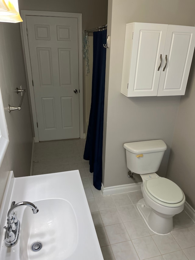 bathroom featuring tile patterned flooring, toilet, and sink