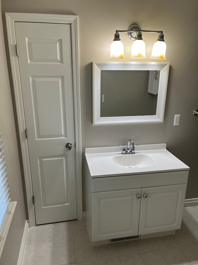 bathroom with tile patterned flooring and vanity