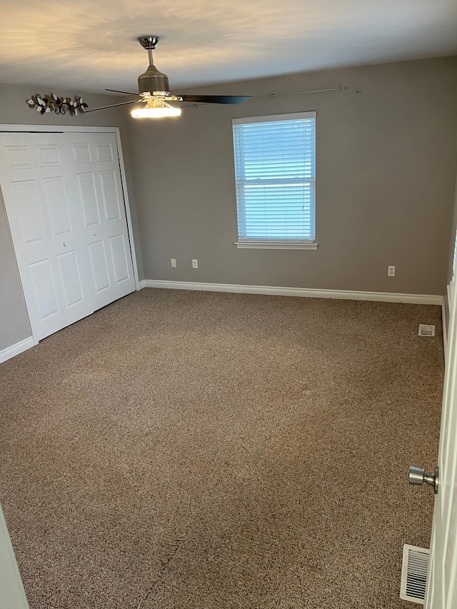 unfurnished bedroom featuring a closet and ceiling fan