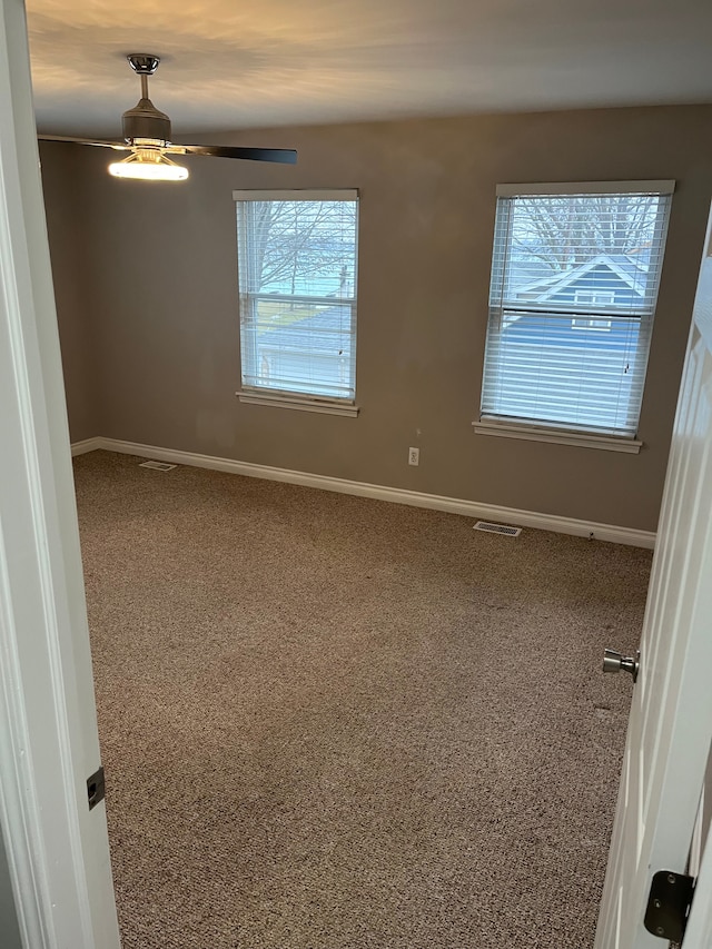 spare room with carpet flooring and ceiling fan